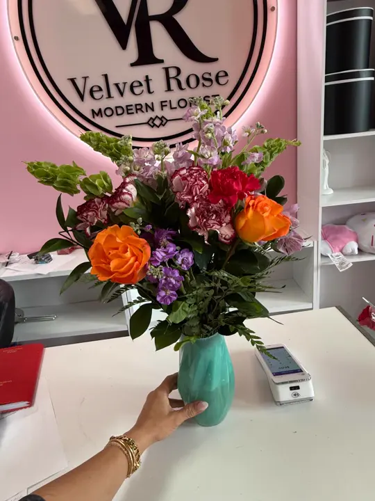 Hand-held mixed rose vase arrangement in the Velvet Rose shop